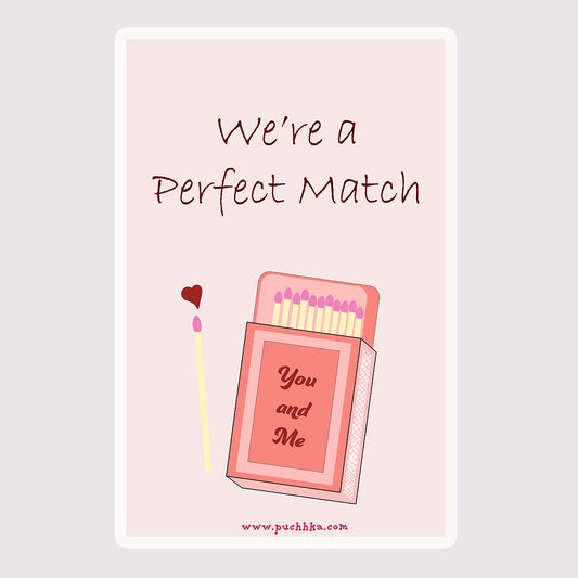 A square greeting card or print with a pale pink background and rounded corners, featuring the words 'We're a Perfect Match' above an illustrated pink matchbox and a single match with a small red heart.