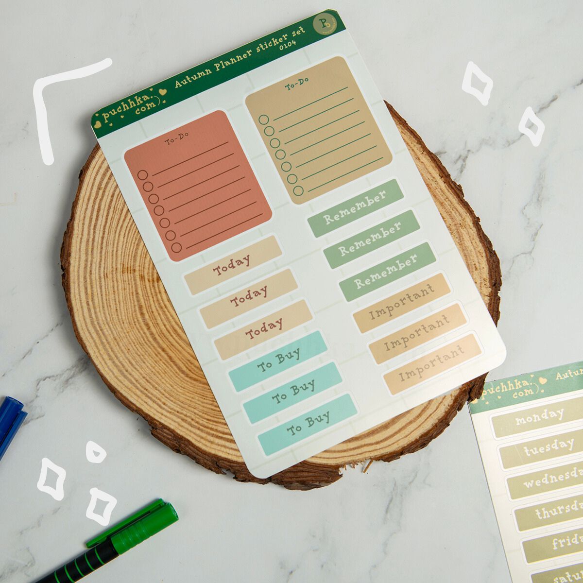 An autumn planner sticker set sheet displayed on a rustic wood slice coaster, featuring various labels and checkboxes in muted fall colors like sage green, terracotta, and beige.