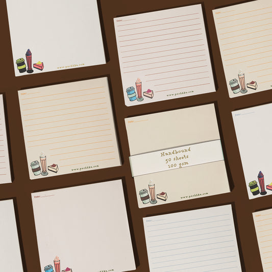 A set of cream-colored lined notepads with a colorful ice cream and cake illustration in the bottom left corner, arranged on a dark brown background. 