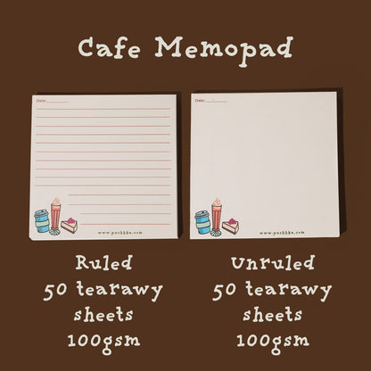 Two sheets of Cafe Memopad notepad paper shown side by side on a dark brown background. The left sheet is ruled and the right sheet is unruled, both with small colorful illustrations at the bottom and text indicating 50 tearaway sheets, 100gsm, and the brand www.