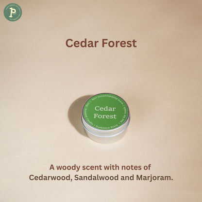 Cedar Forest Scented Mini Candle is on a beige background with notes of "Cedarwood, Sandalwood and Marjoram" written at the bottom.