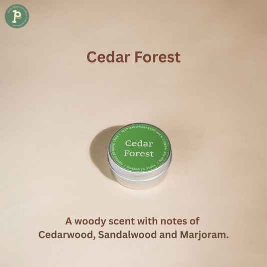 Cedar Forest Scented Mini Candle is on a beige background with notes of "Cedarwood, Sandalwood and Marjoram" written at the bottom.