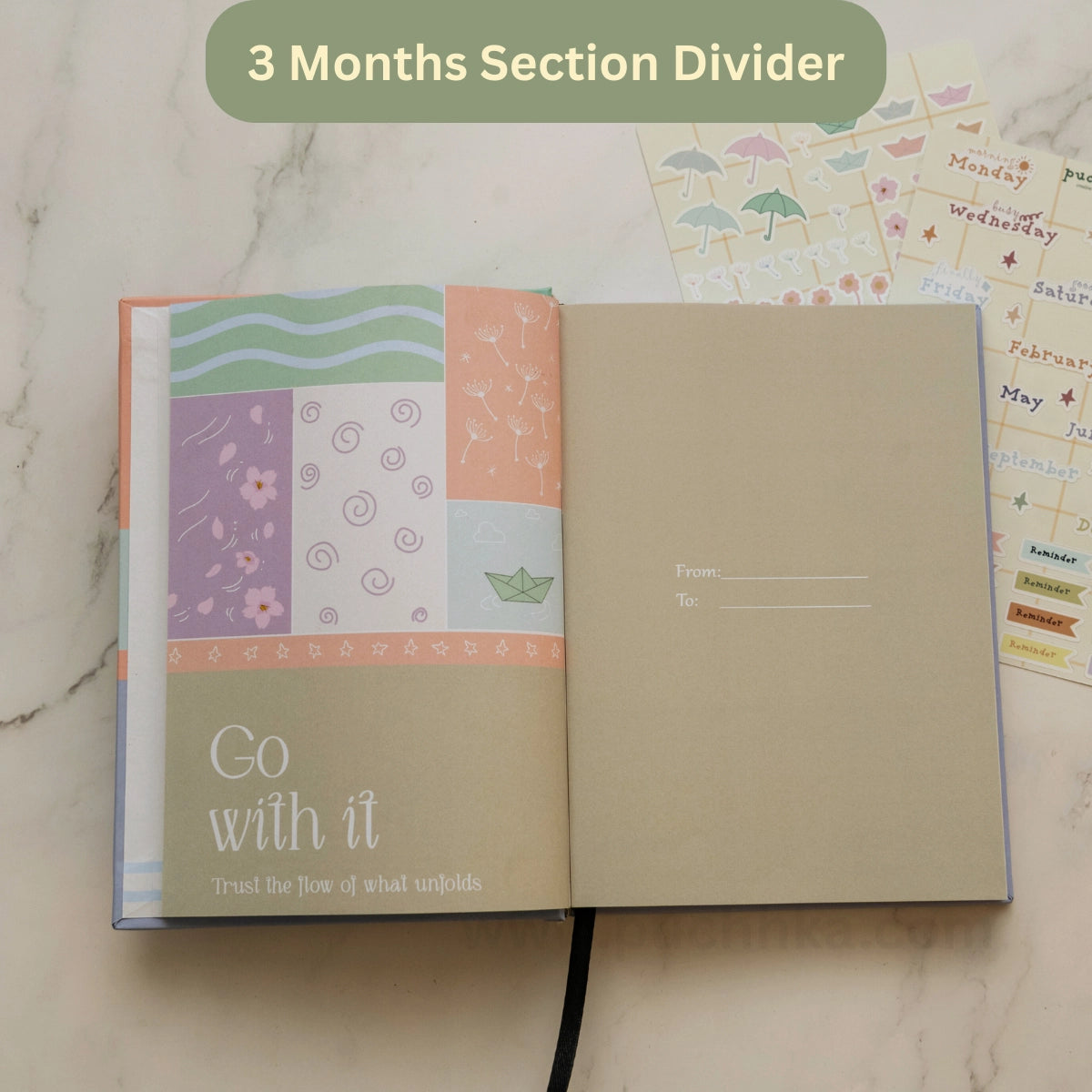 An open planner showing a pastel patchwork section divider page with the text 'Go with it'.