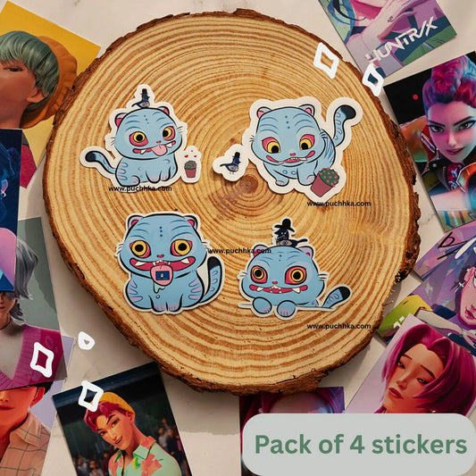 Four cute derpy tiger and pigeon stickers, arranged on a round wood slice with scattered character posters around it. A label at the bottom reads 'Pack of 4 stickers'.