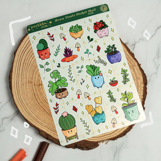 A sticker sheet titled 'puchka.com House Plants Sticker Sheet' featuring cute cartoon plant pots and small gardening motifs, placed on a round wood slice over a light marble surface.