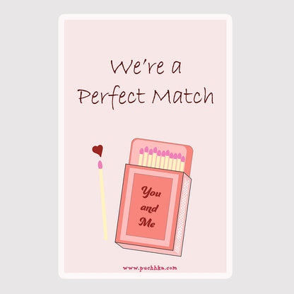 A square greeting card or print with a pale pink background and rounded corners, featuring the words 'We're a Perfect Match' above an illustrated pink matchbox and a single match with a small red heart.