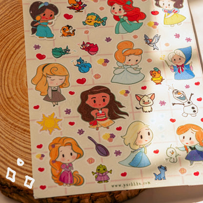 A sheet of cute cartoon character stickers featuring Disney princesses, displayed on a wooden surface.