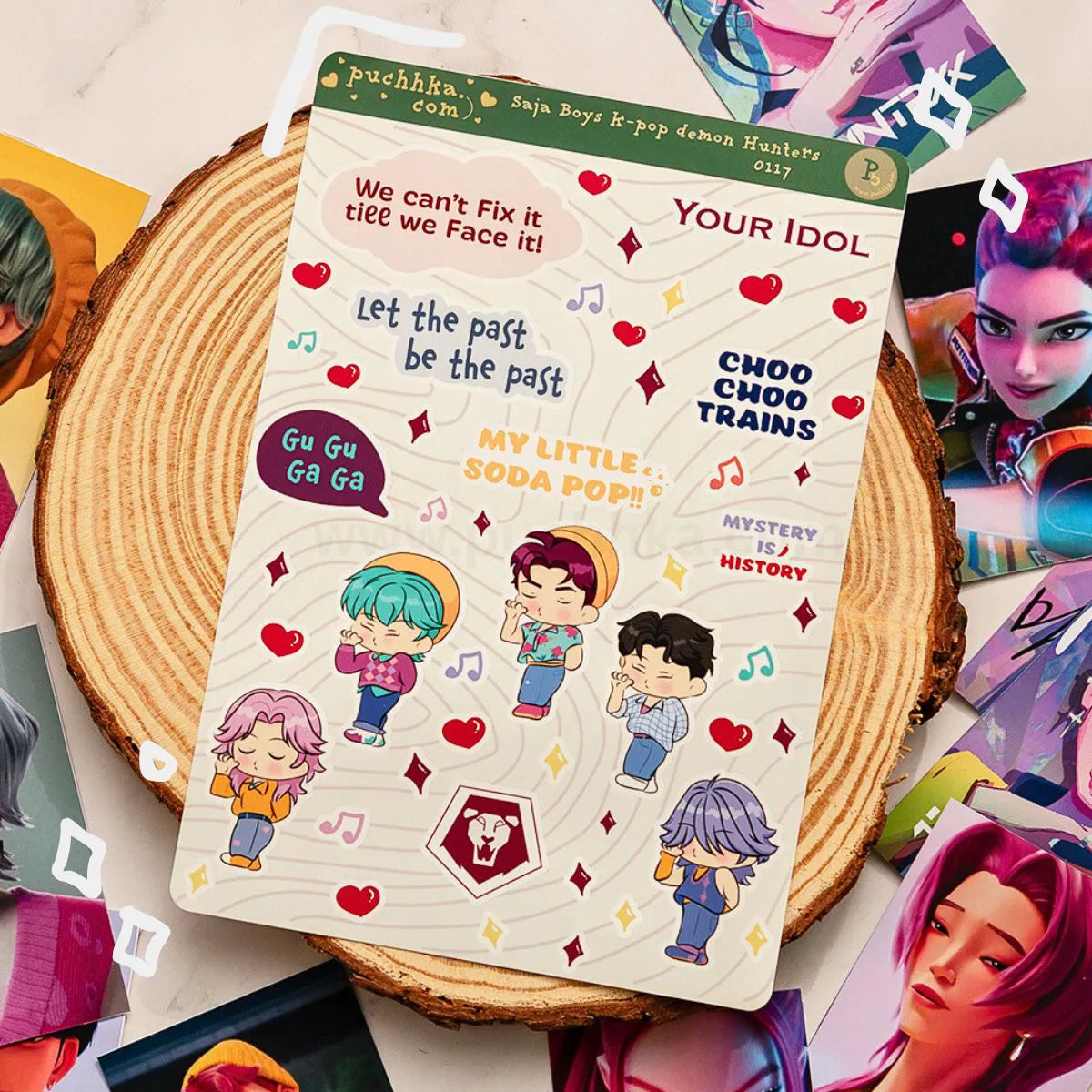 A sheet of cute anime-style stickers featuring characters and phrases like 'Let the past be the past' and 'MY LITTLE SODA POP!', displayed on a rustic wood slice surrounded by colorful character art cards.