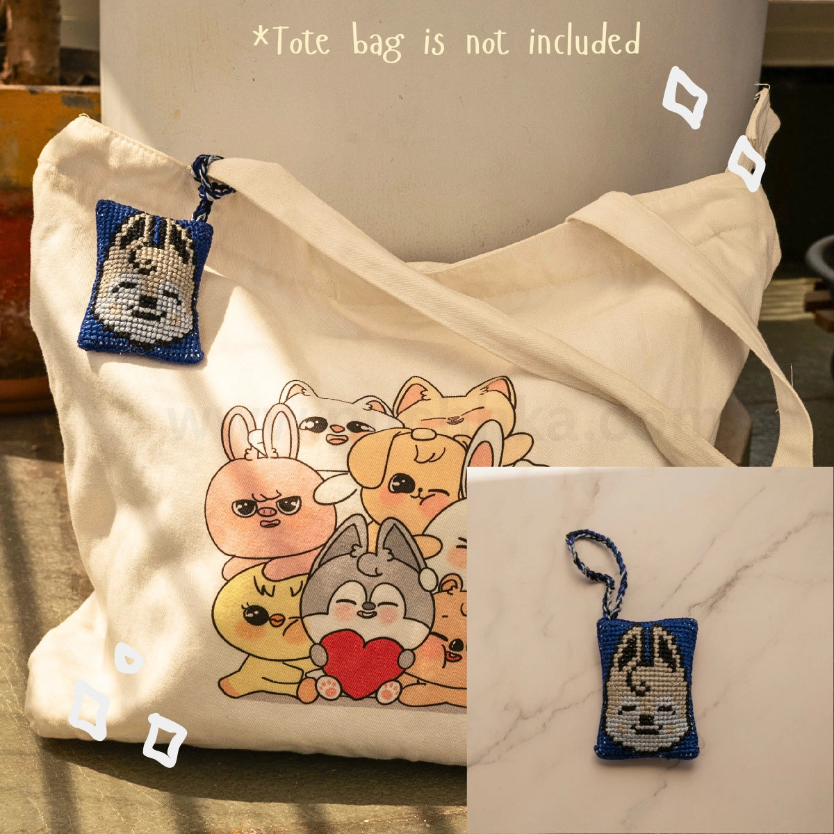 A cream canvas tote bag with a printed skzoo illustration on the front, shown alongside a small blue and white cross-stitch style skzoo bag hanging with a matching strap. The image includes text stating '*Tote bag is not included' and a small inset showing the pouch alone on a marble surface.