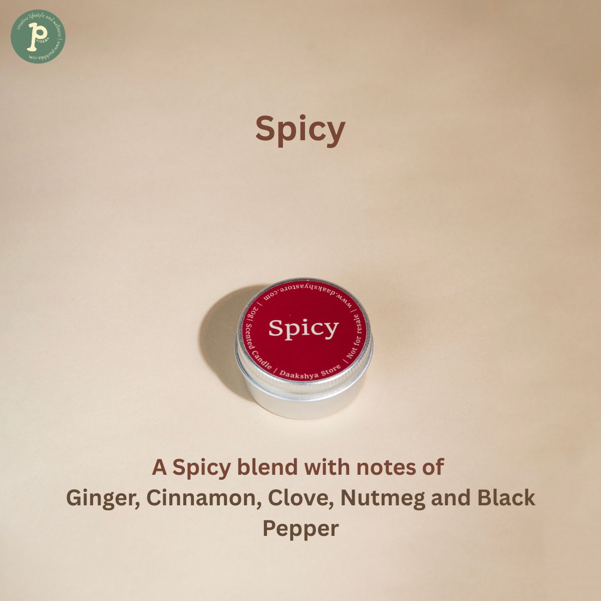 Spicy scented mini candle is on a beige background with notes of "Ginger, Cinnamon, Clove, Nutmeg and Black Pepper" written at the bottom.