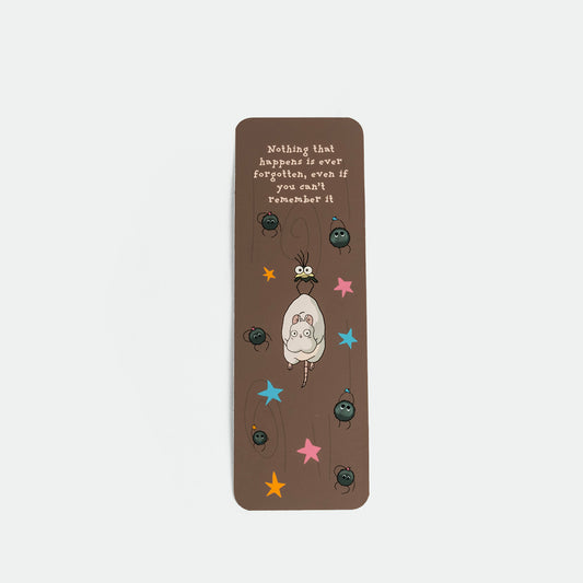 A brown rectangular bookmark featuring a ghibli illustration , colorful stars, and the quote 'Nothing that happens is ever forgotten, even if you can't remember it.'.
