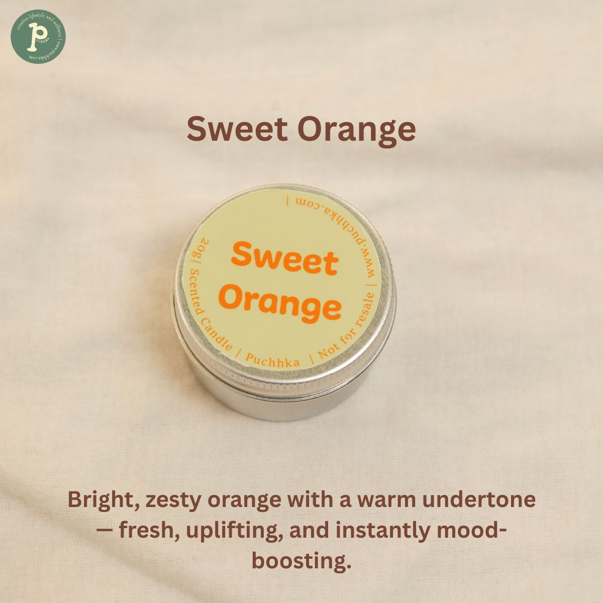 Sweet Orange scented mini candle is on a linen background with notes of zesty orange and warm undertone written at the bottom.
