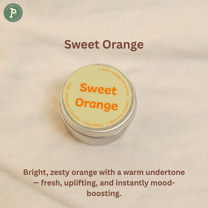 Sweet Orange scented mini candle is on a linen background with notes of zesty orange and warm undertone written at the bottom.