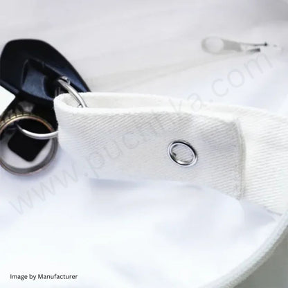 Close-up of a white fabric strap or belt section with a silver metal grommet and attached key ring, shown on a white background with a blurred key and small watermark text.