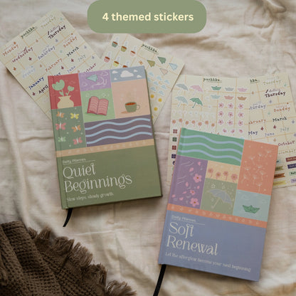 Two Daily Planners  titled 'Quiet Beginnings' and 'Soft Renewal' are arranged on a cream fabric background with a brown knit blanket. Several sheets of themed stickers are spread out behind them, and a green badge at the top reads '4 themed stickers'.